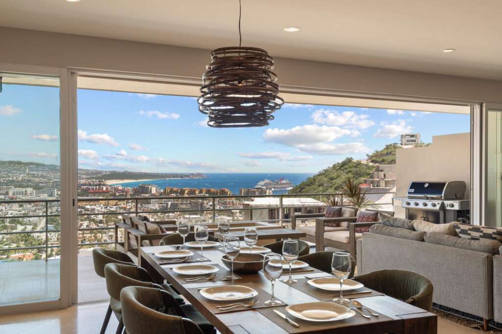 Los Cabos Morgan Residences Morgan Residences Condo 306 offers 67 m² of functional living space with one bedroom, one and a half baths, and a private balcony overlooking the city. The open floor plan connects the kitchen, dining, and living areas with marble-style tile throughout. The kitchen has granite counters, white cabinets, and an island with seating. The bedroom includes an ensuite bathroom with a walk-in shower and opens to the terrace. A separate half bath includes in-unit laundry. The building features a rooftop pool, gym, BBQ area, and – Cascadas Condo 722, Cabo San Lucas, Cabo San Lucas, BS