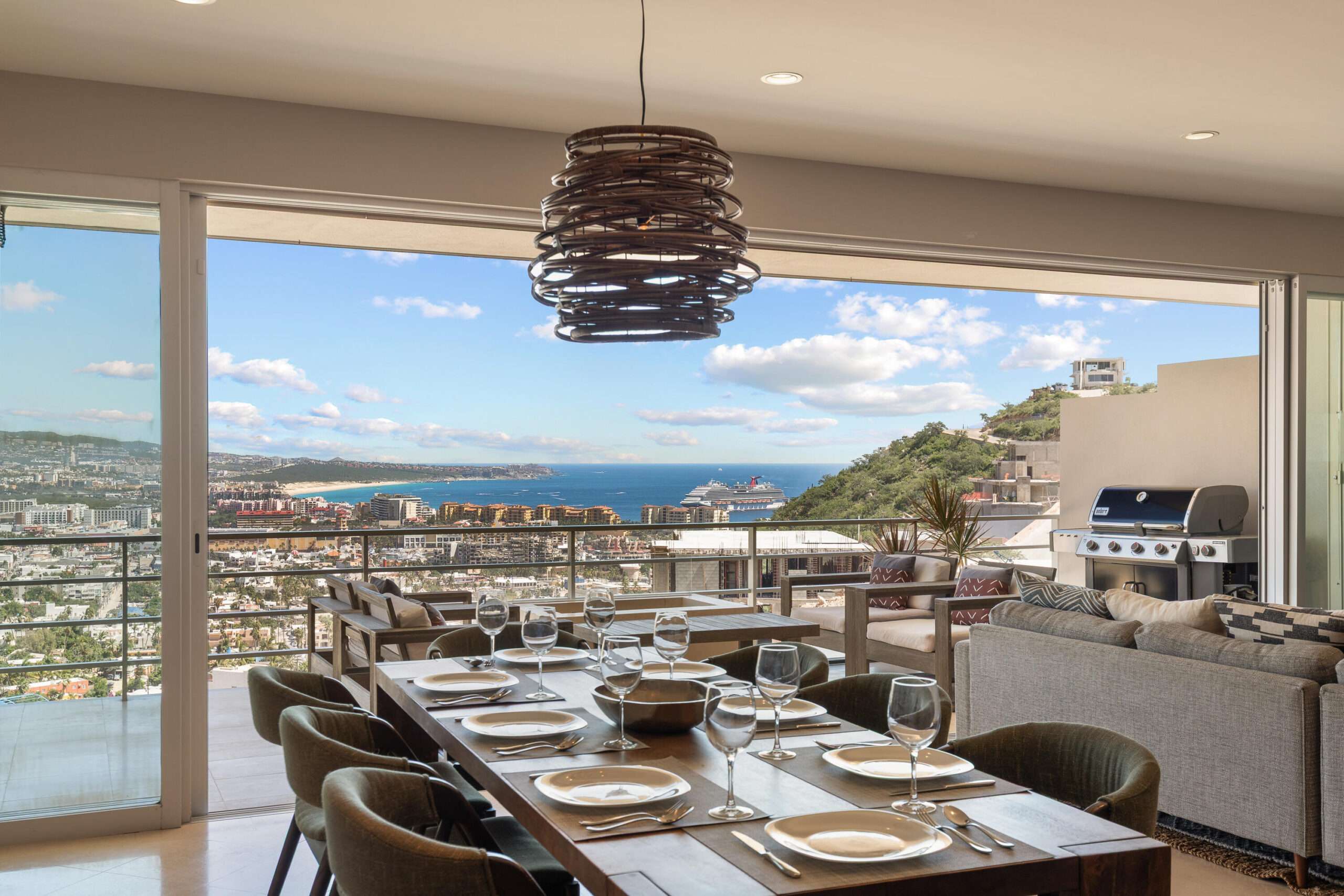 Los Cabos Morgan Residences Morgan Residences Condo 306 offers 67 m² of functional living space with one bedroom, one and a half baths, and a private balcony overlooking the city. The open floor plan connects the kitchen, dining, and living areas with marble-style tile throughout. The kitchen has granite counters, white cabinets, and an island with seating. The bedroom includes an ensuite bathroom with a walk-in shower and opens to the terrace. A separate half bath includes in-unit laundry. The building features a rooftop pool, gym, BBQ area, and for sale