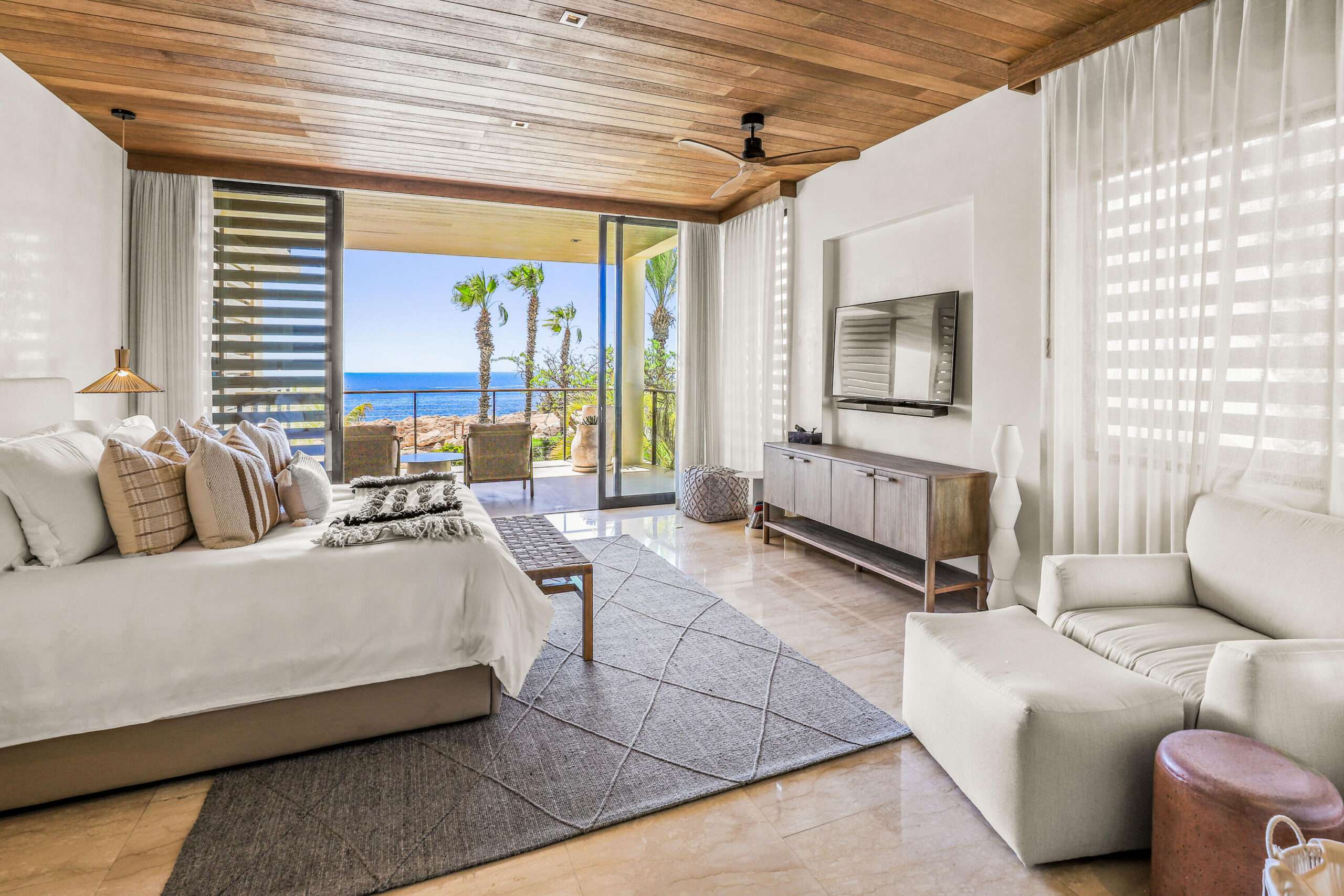 Los Cabos Morgan Residences Morgan Residences Condo 306 offers 67 m² of functional living space with one bedroom, one and a half baths, and a private balcony overlooking the city. The open floor plan connects the kitchen, dining, and living areas with marble-style tile throughout. The kitchen has granite counters, white cabinets, and an island with seating. The bedroom includes an ensuite bathroom with a walk-in shower and opens to the terrace. A separate half bath includes in-unit laundry. The building features a rooftop pool, gym, BBQ area, and for sale
